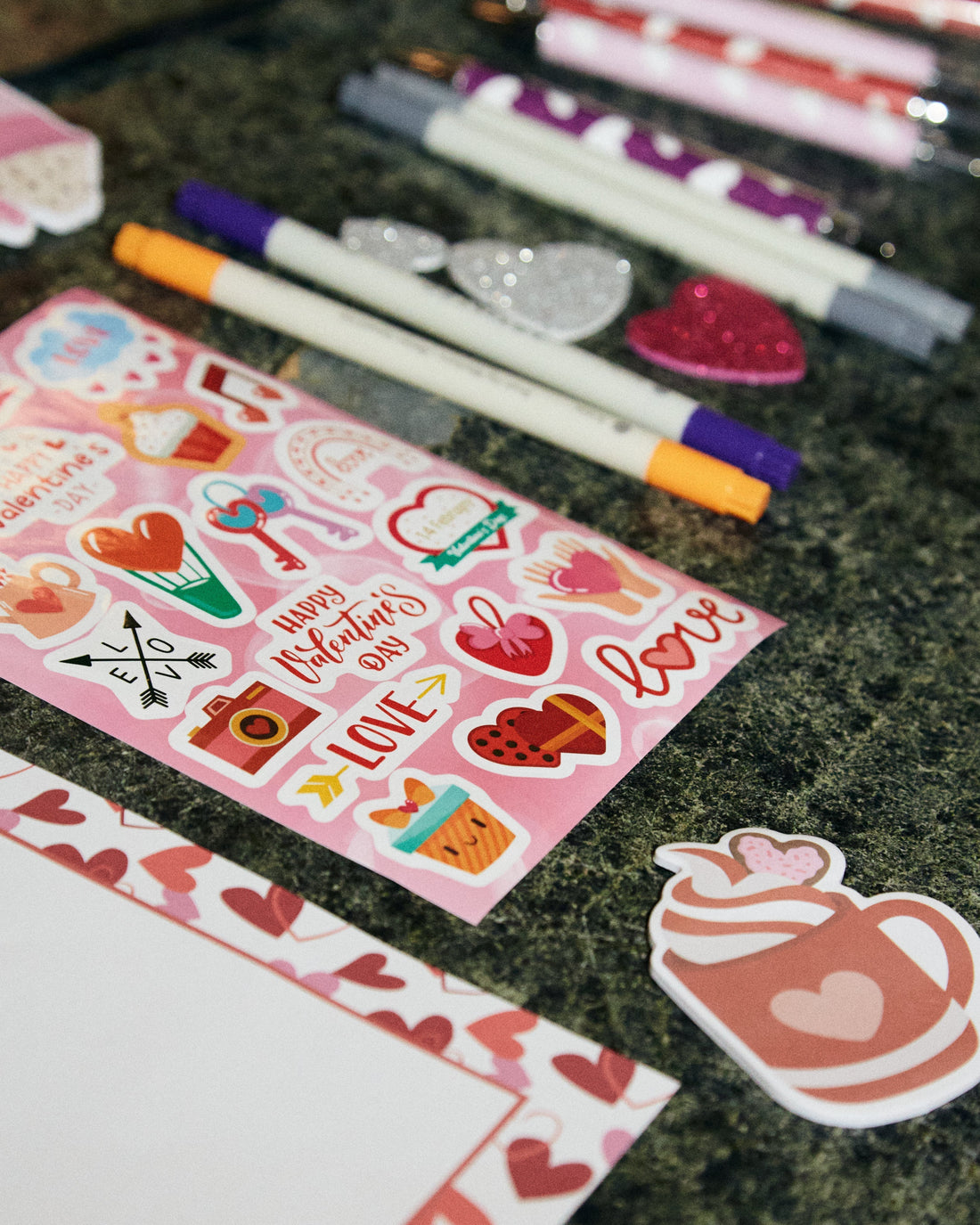 Valentine’s themed stickers, pens, and stationery laid out on a table for the Isshiki Matcha Valentine’s Workshop, highlighting creative supplies used for letter writing during the matcha event.