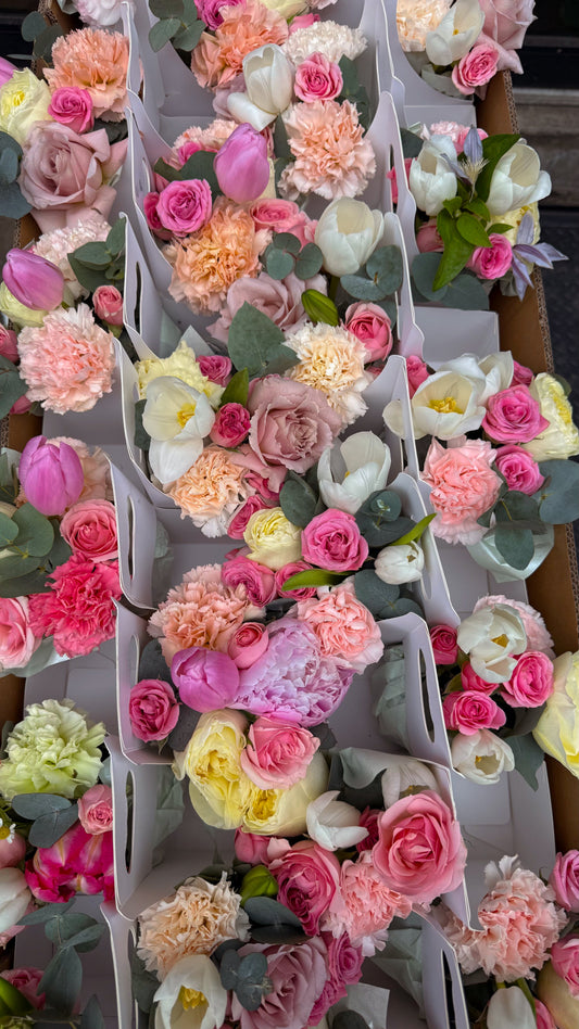 Rows of pastel mini flower bouquets arranged in carriers for the International Women’s Day collaboration between Isshiki Matcha and Ruscus Flowers.