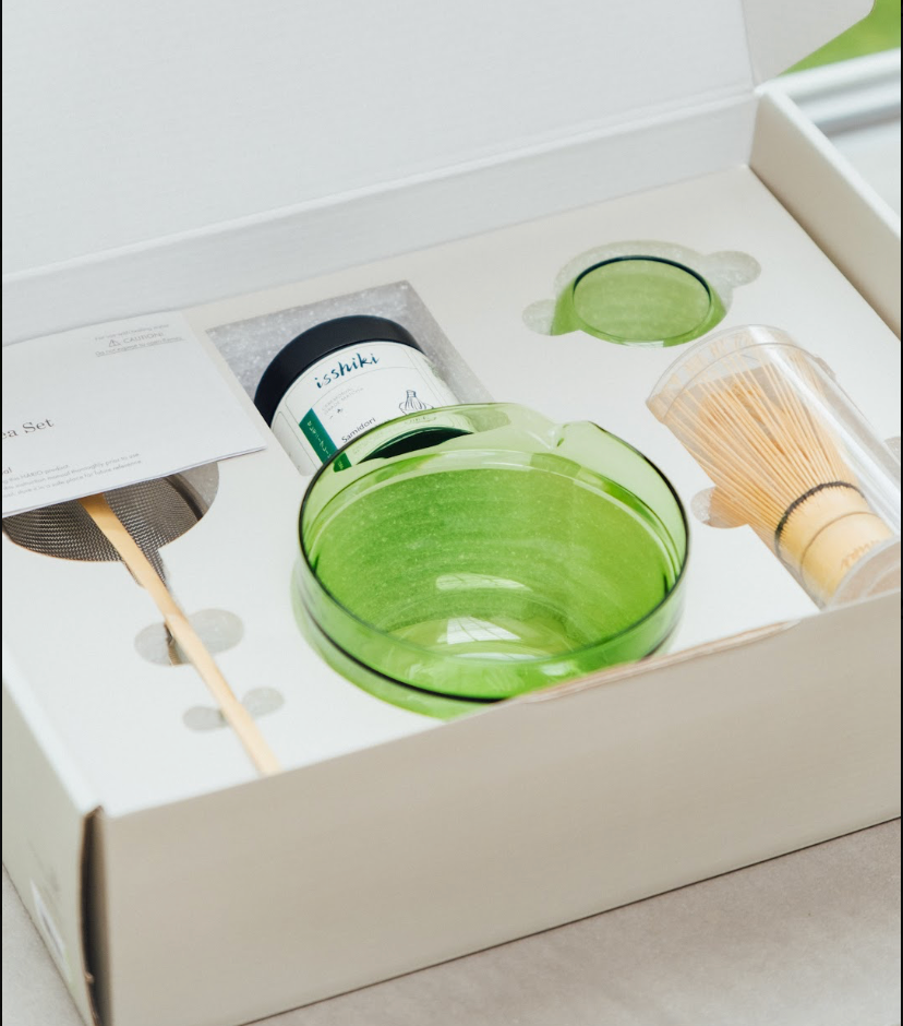 Isshiki x Hario green matcha set in its gift box with glass bowl, matcha tin, bamboo whisk and scoop in a fitted tray