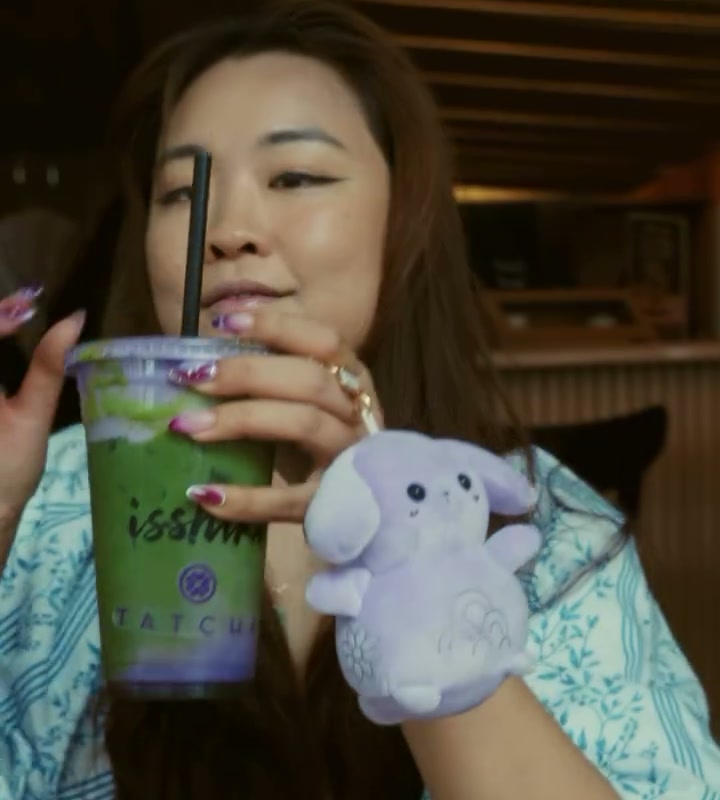 Angel Zheng holding an Isshiki matcha drink in New York's East Village