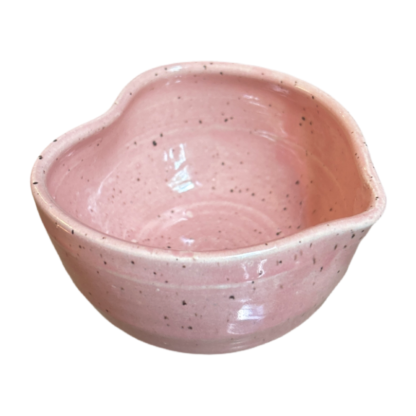 Speckled pink heart-shaped matcha bowl with glossy glaze and small pouring spout
