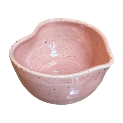 Speckled pink heart-shaped matcha bowl with glossy glaze and small pouring spout
