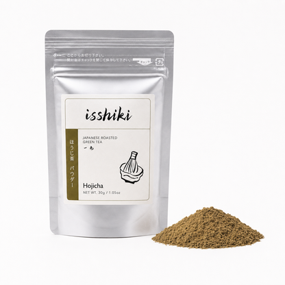 Isshiki Hojicha roasted green tea pouch beside brown Hojicha powder on white