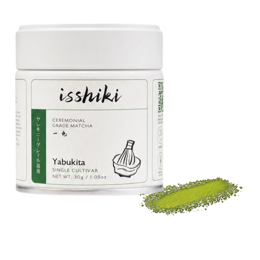 Isshiki Yabukita matcha tin beside a yellow-green Yabukita powder smear
