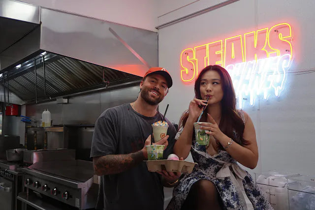 Two guests holding Isshiki matcha drinks