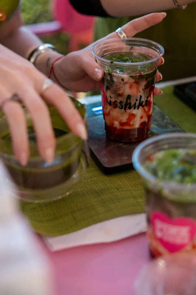 A layered Isshiki matcha drink being finished at the bar